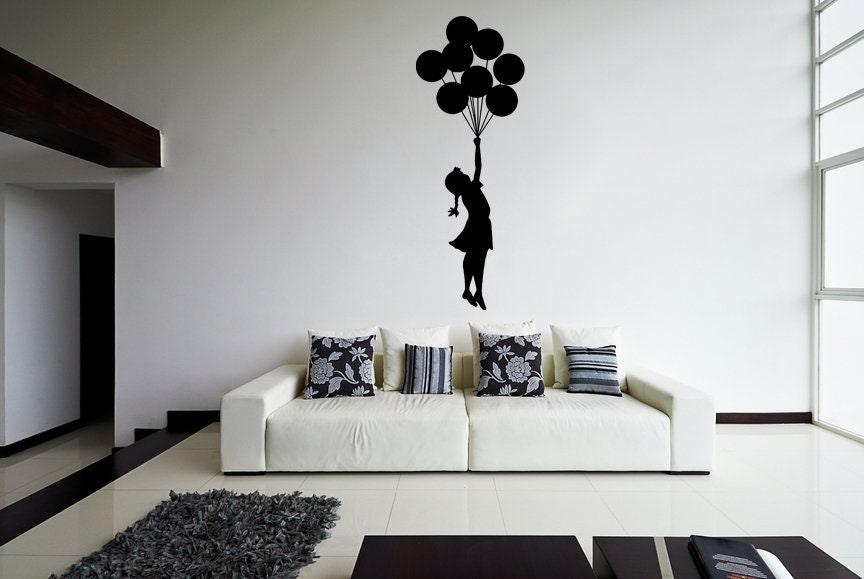 Banksy Girl With Balloons wall decal in modern living room, showcasing iconic street art design.