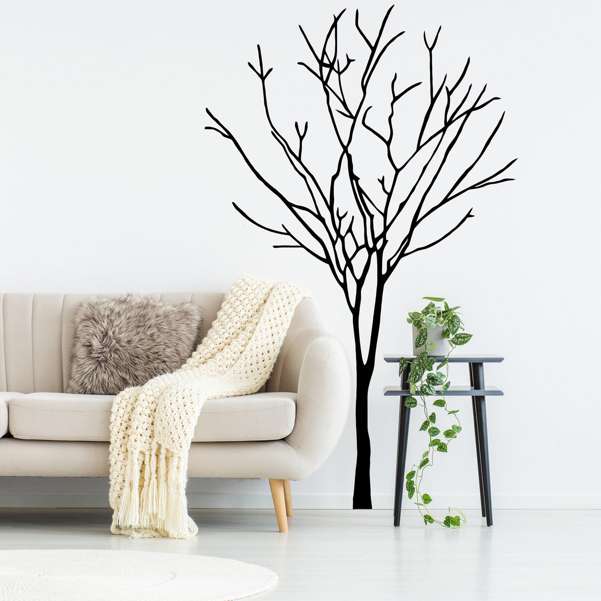 Birch tree wall decal in a modern living room with cozy couch and decor, perfect for nursery or home styling.