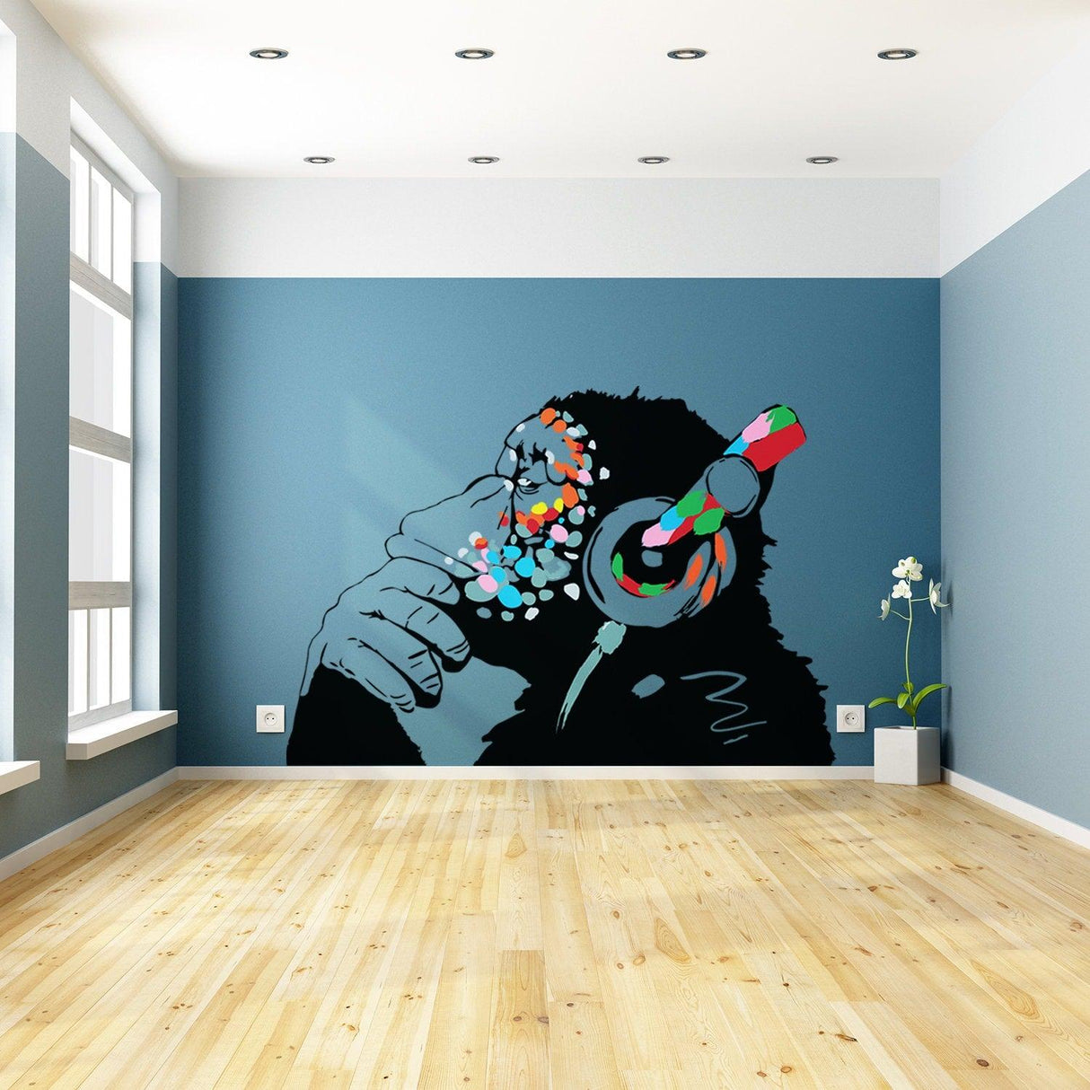 Banksy-inspired monkey wall art sticker with colorful headphones in modern room setting.