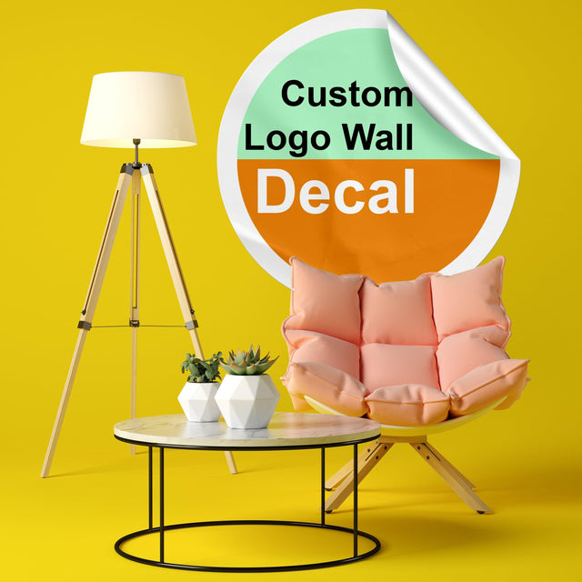 Custom logo wall decal displayed in a modern interior with a lamp and cozy chair.