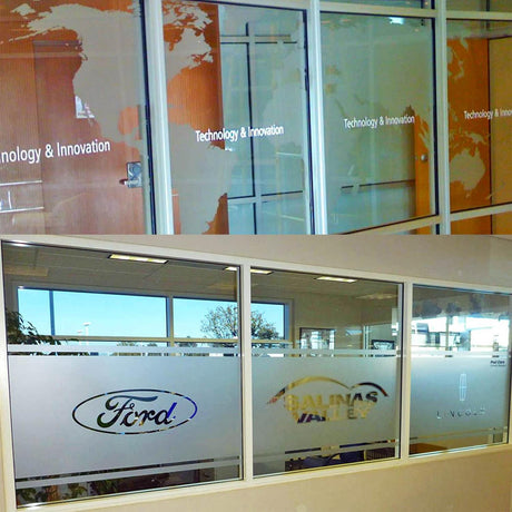 Custom frosted window film displaying 'Technology & Innovation' and logos of Ford and Lincoln on glass doors.