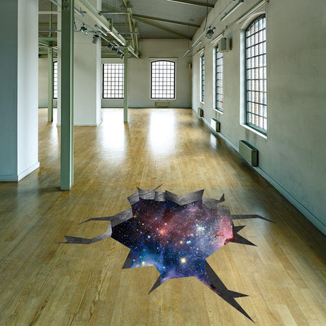3D floor space portal hole decal featuring galaxy art in an empty room with wooden flooring.
