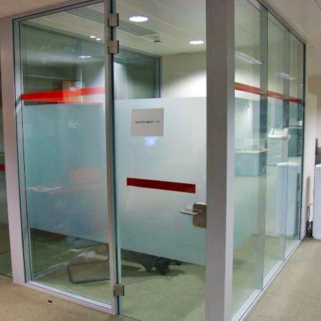 Frosted window film sticker on a glass office door, offering privacy and style with a sleek design.