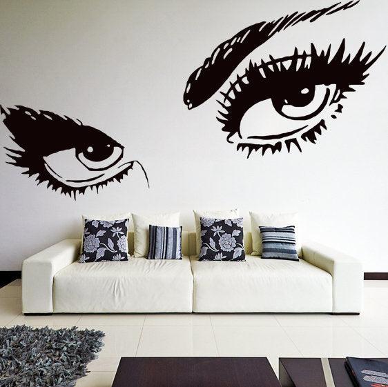 Elegant woman eyes wall decal featuring long eyelashes, enhancing bedroom decor with feminine style.