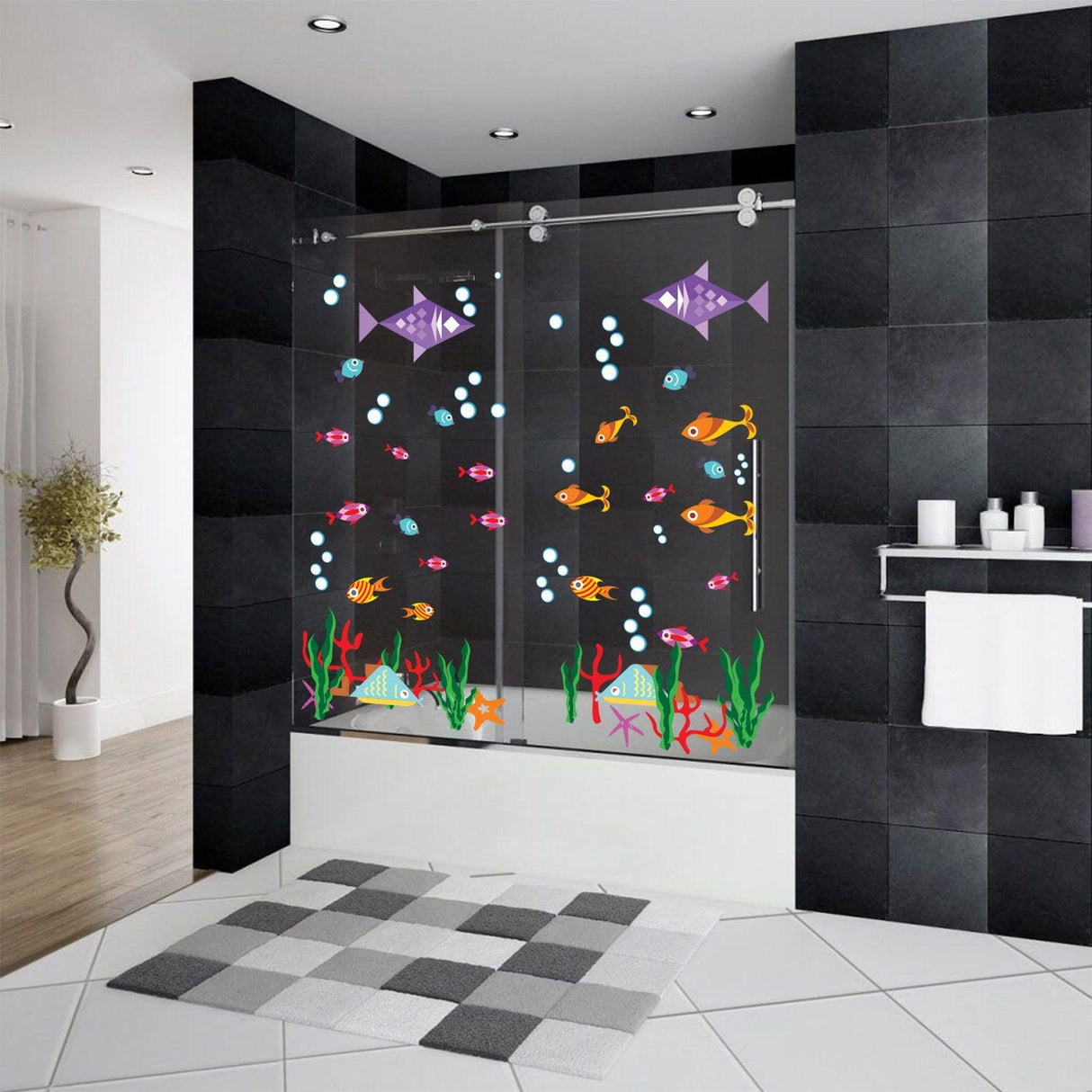 Colorful ocean animal fish wall decal in a modern bathroom with black tiles and white accessories.