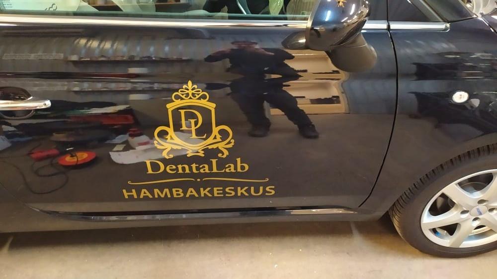 Custom car decal on a black vehicle featuring 'DentalLab' branding for personalized automotive accents.