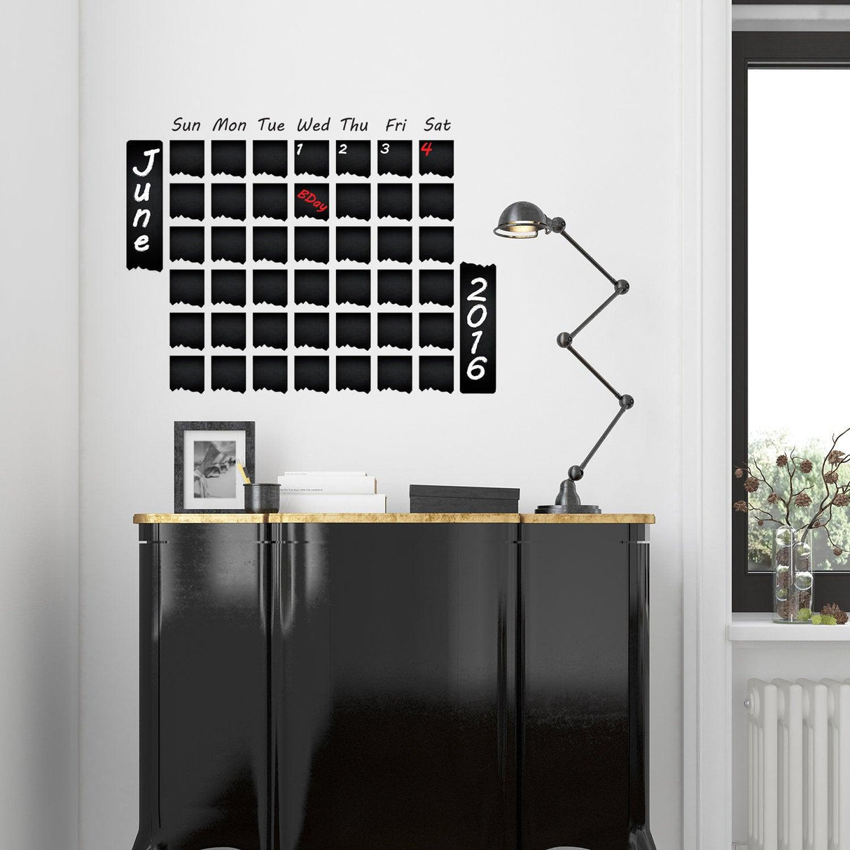Chalkboard wall planner sticker in a modern kitchen, showcasing a monthly calendar for June 2017 with days of the week.