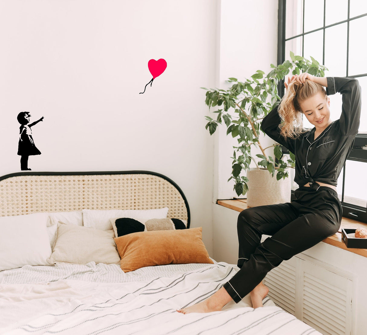 Banksy Girl With The Red Balloon Wall Decal in stylish bedroom setting with cozy decor.