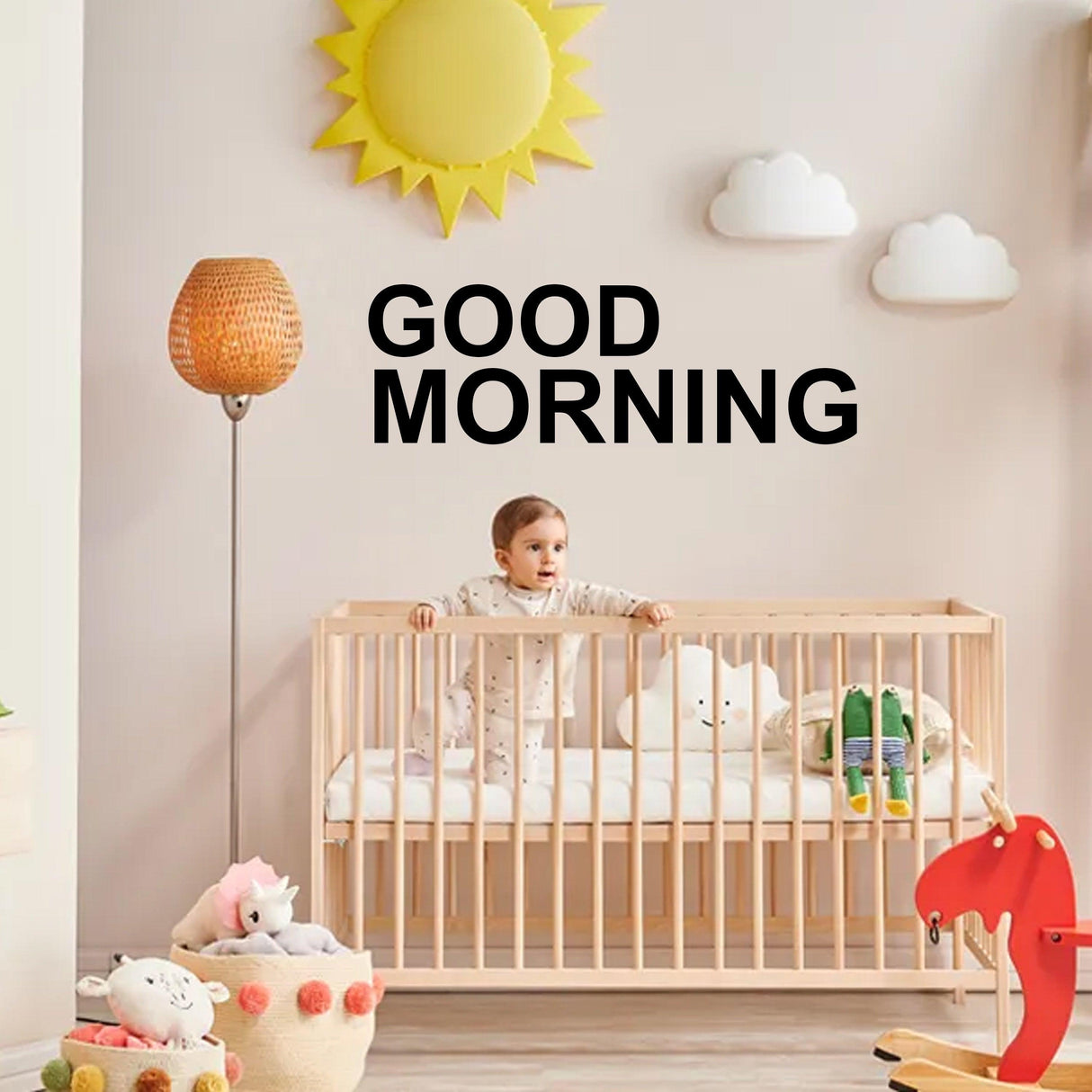 Child in a crib with removable vinyl letter stickers saying 'Good Morning' on the wall.