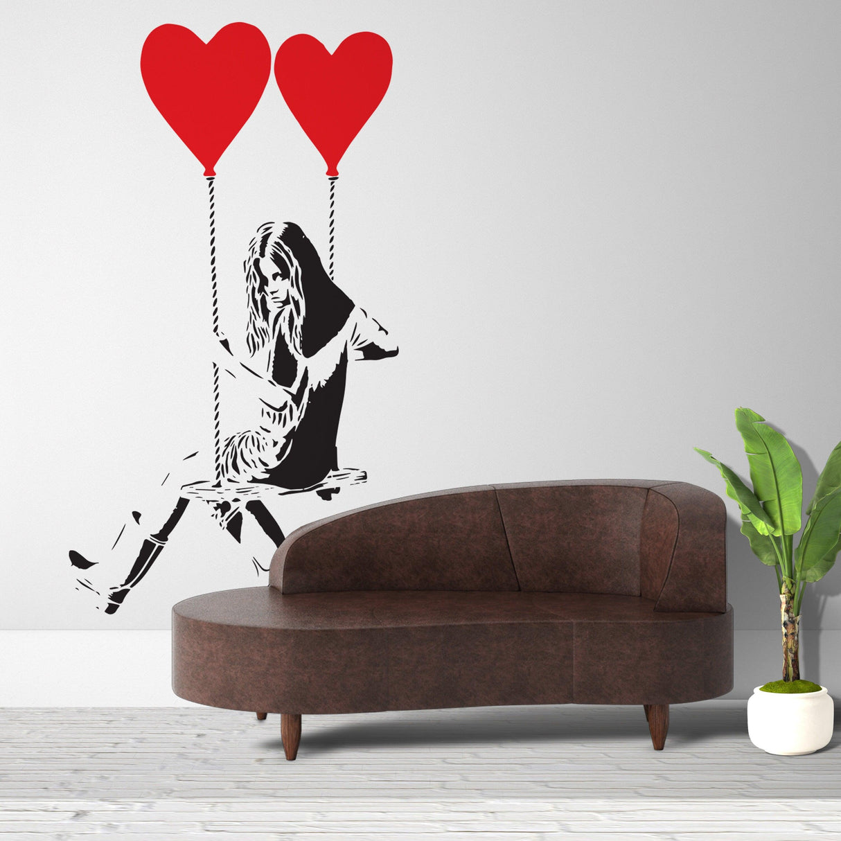 Banksy Girl With Heart Balloon wall sticker above a stylish couch, adding pop art decor to any room.
