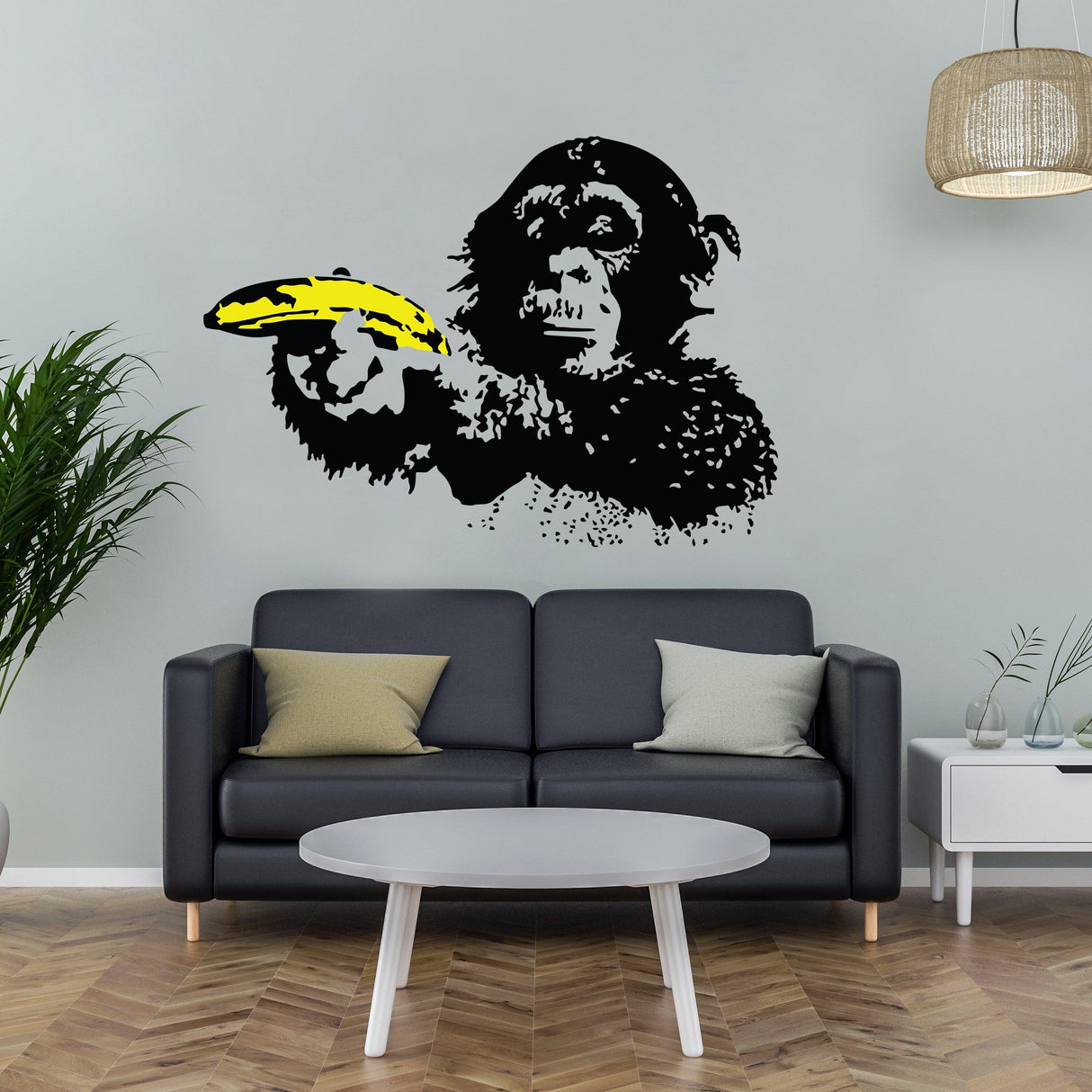 Banksy monkey wall sticker featuring a monkey with a yellow banana in an urban living room setting.