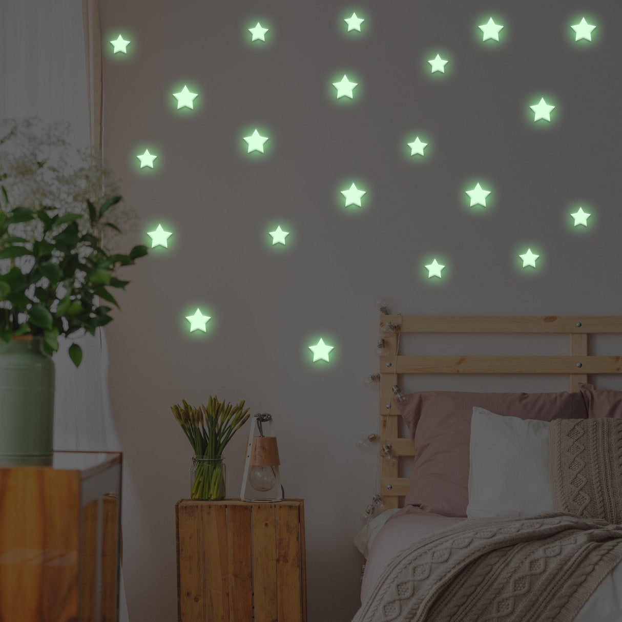Glow in the dark star stickers on a bedroom wall, creating a magical starry effect for kids' room decor.