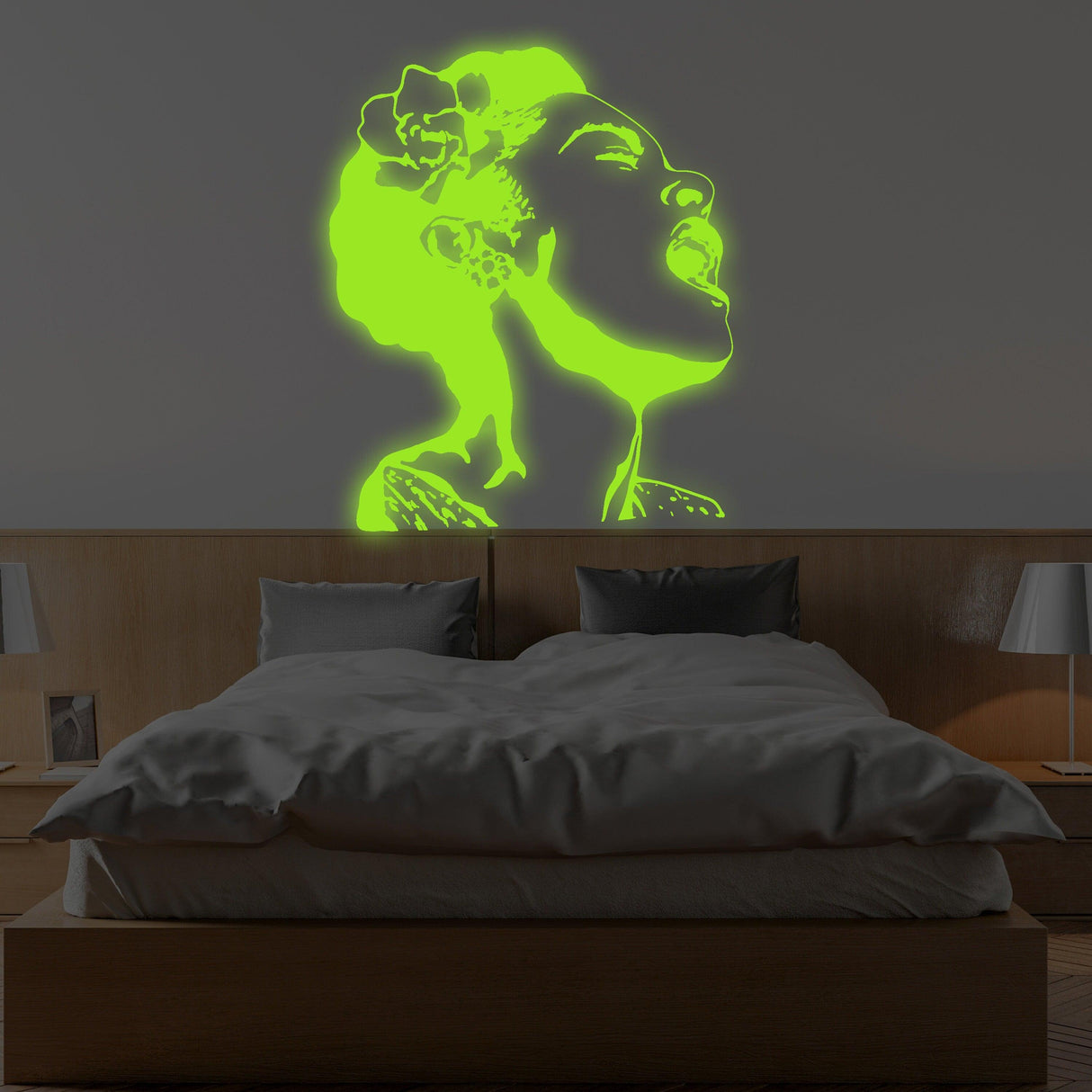 Glow in dark Banksy street art wall decal of a singing woman, neon green, illuminating a bedroom wall.