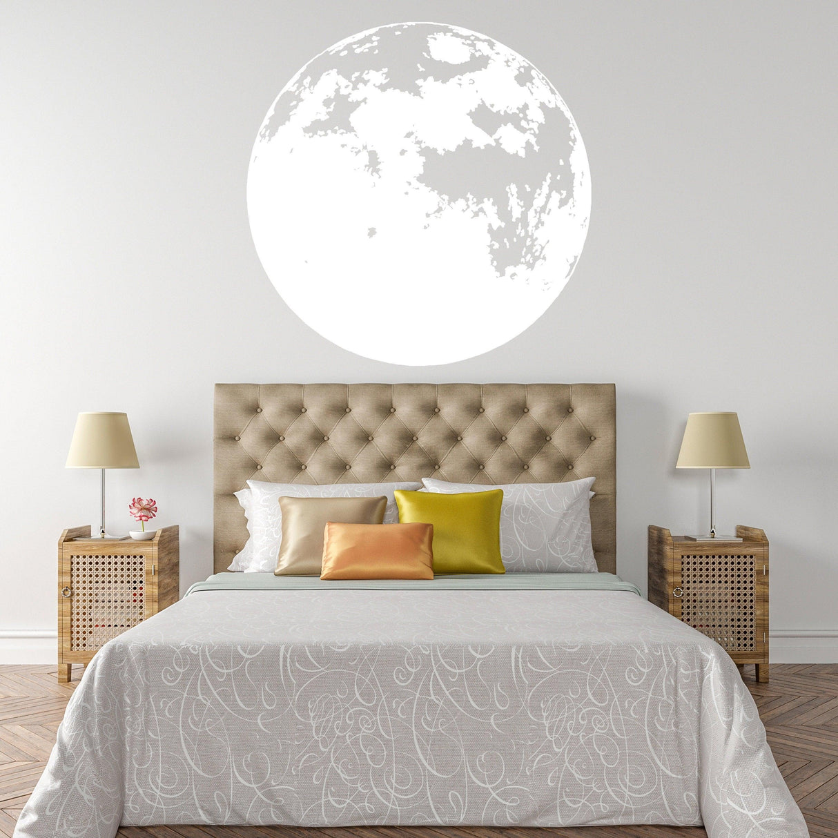 Large glow-in-the-dark moon wall decal above a cozy bed in a nursery or kids' room.