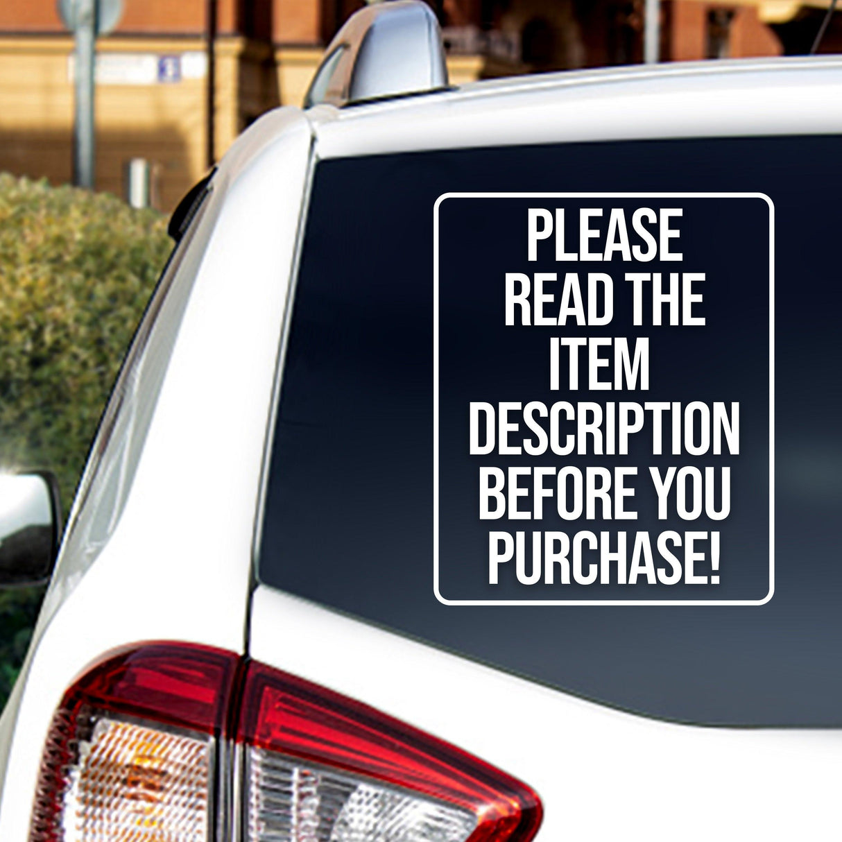 Car window decal with text 'Please read the item description before you purchase!' on a vehicle's rear windshield.