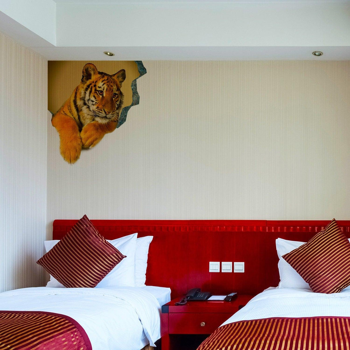 3D tiger wall decal in a bedroom, featuring a realistic tiger face emerging from the wall above two beds.