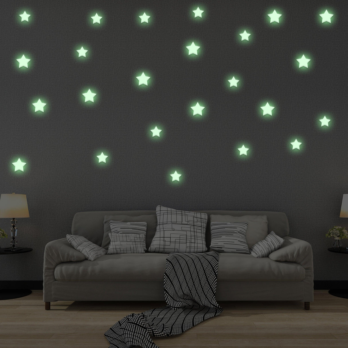 Glow in the dark star stickers on a dark wall above a cozy sofa, creating a magical night sky ambiance.