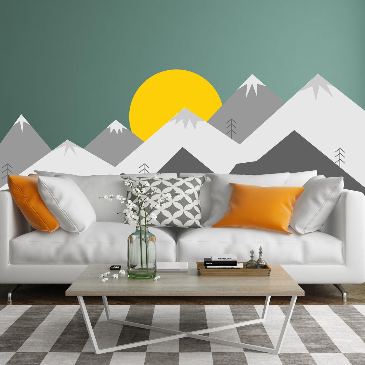 Mountain wall decal with sun above, enhancing a modern nursery with a cozy sofa and decorative pillows.