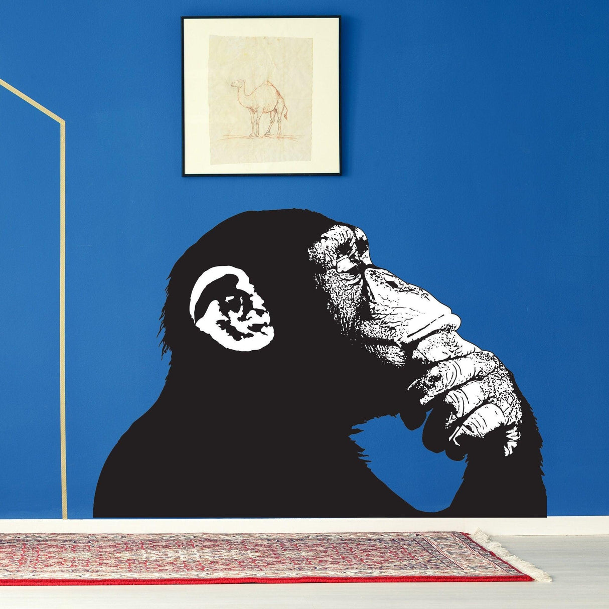 Thinking Monkey wall sticker in black and white on a blue wall, showcasing a monkey deep in thought, ideal for modern decor.