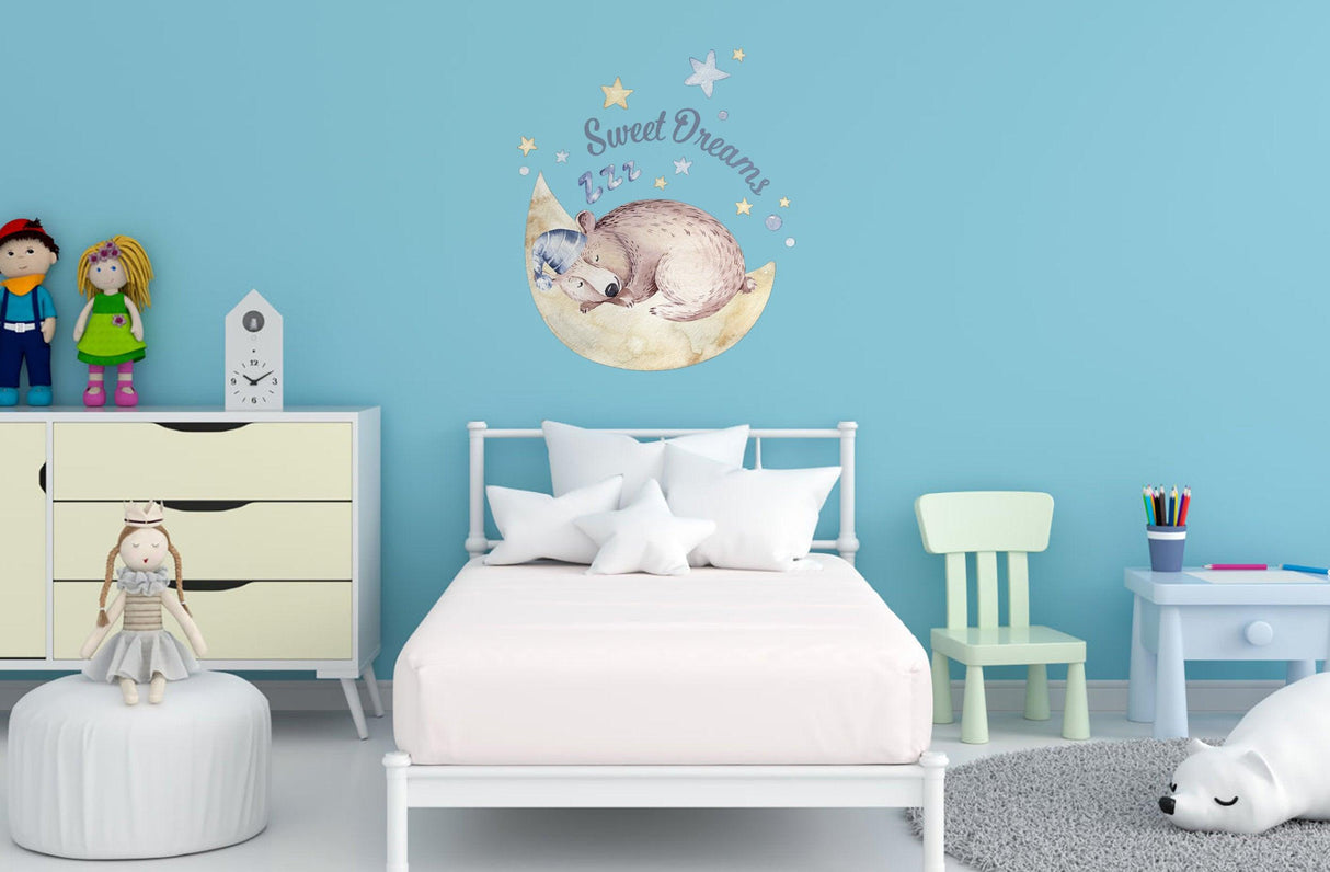 Baby nursery with Dream Wall Sticker of a sleeping animal, adding charm to a cozy room for kids.