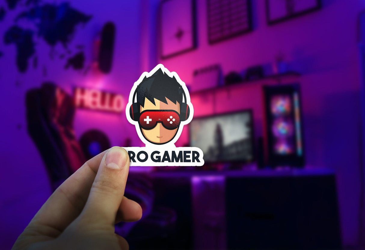 Hand holding a custom Pro Gamer die cut sticker in a stylish gaming setup with bold colors.