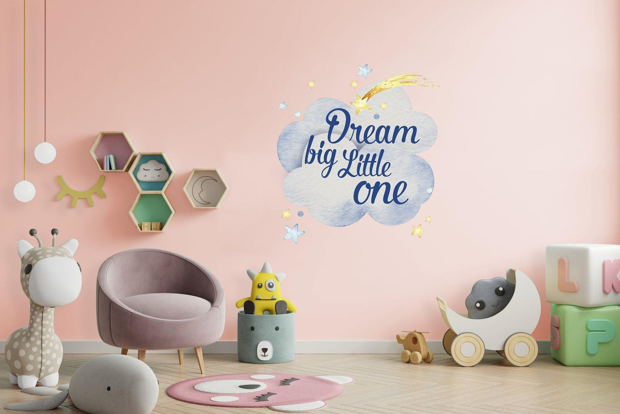 Dream big Little one wall sticker in a colorful baby nursery with plush toys and pastel decor.