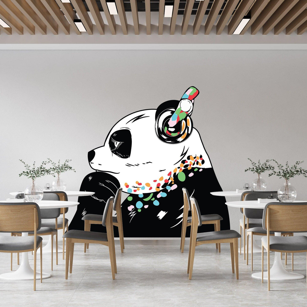Large panda wall sticker with headphones and colorful decorations in a modern dining area.