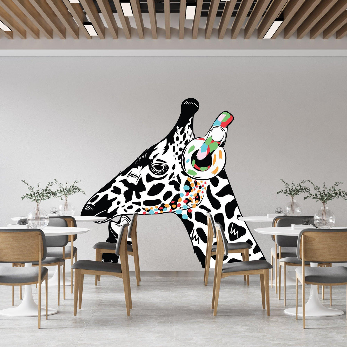 Giraffe wall art sticker featuring a colorful giraffe head with headphones in a modern dining space.