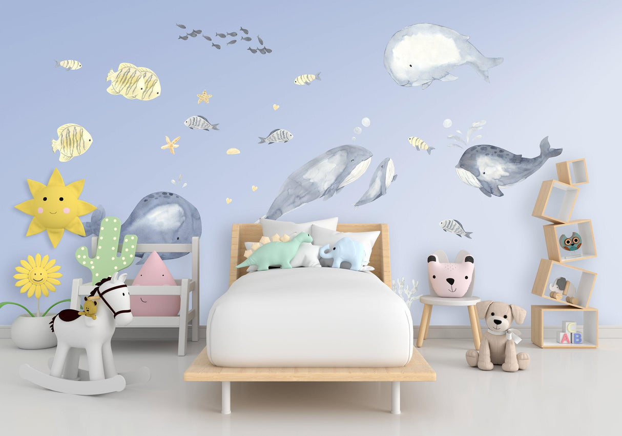 Colorful sea whales wall sticker in a baby boy's nursery, creating a whimsical fish-themed decor.