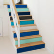 Gradient color self-adhesive stairs risers stickers on a wooden staircase, transforming its appearance with vibrant hues.