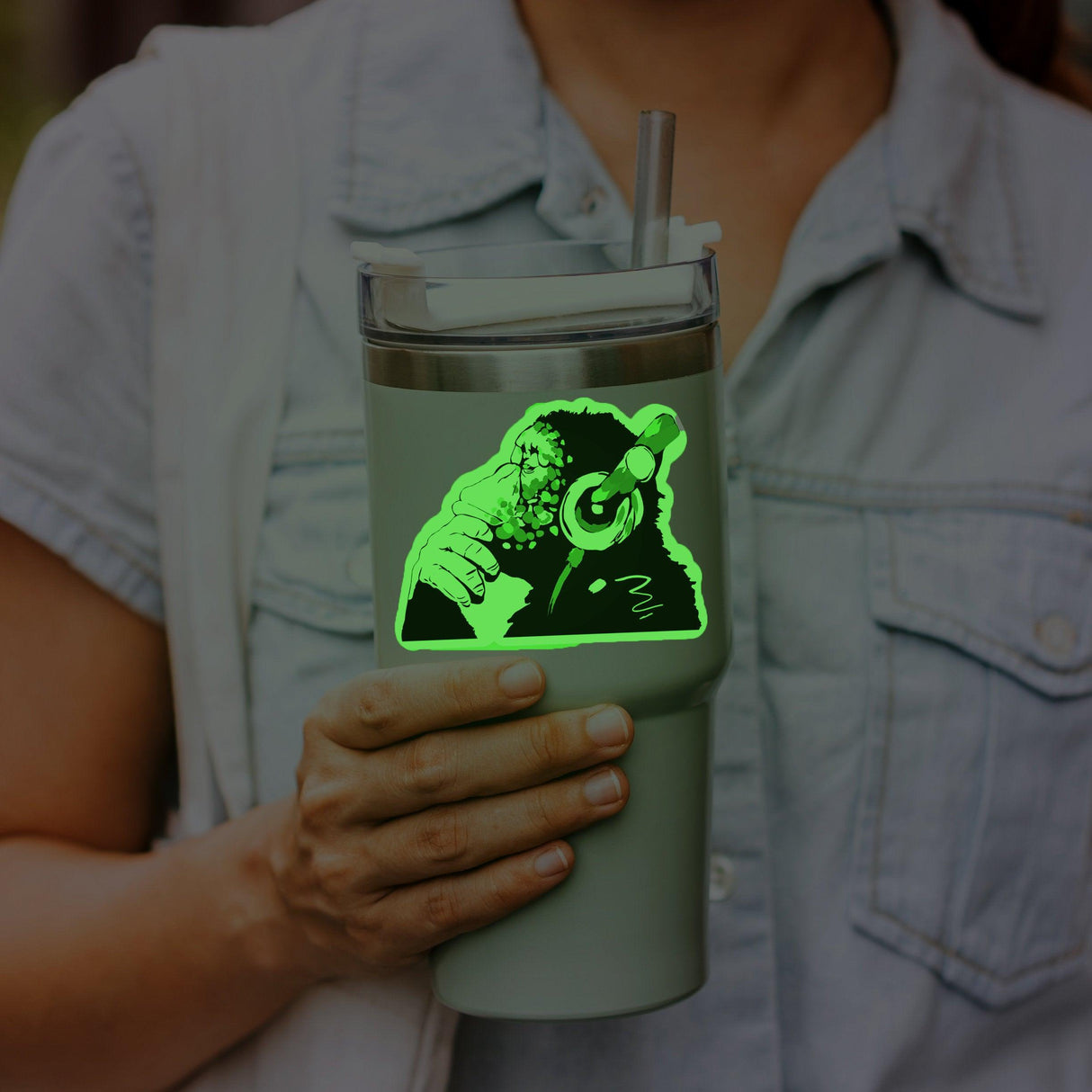 Glow in the Dark Monkey vinyl sticker on a travel tumbler held by a person, perfect for music lovers.