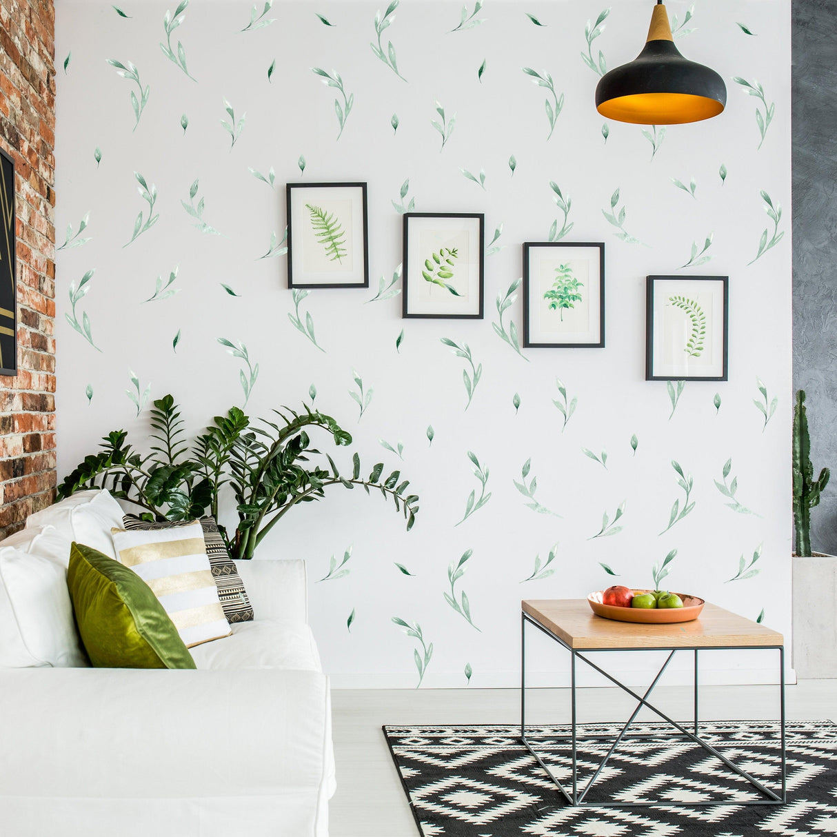 Leaf wall decor stickers in a stylish living room, featuring green leaf designs and framed botanical art.