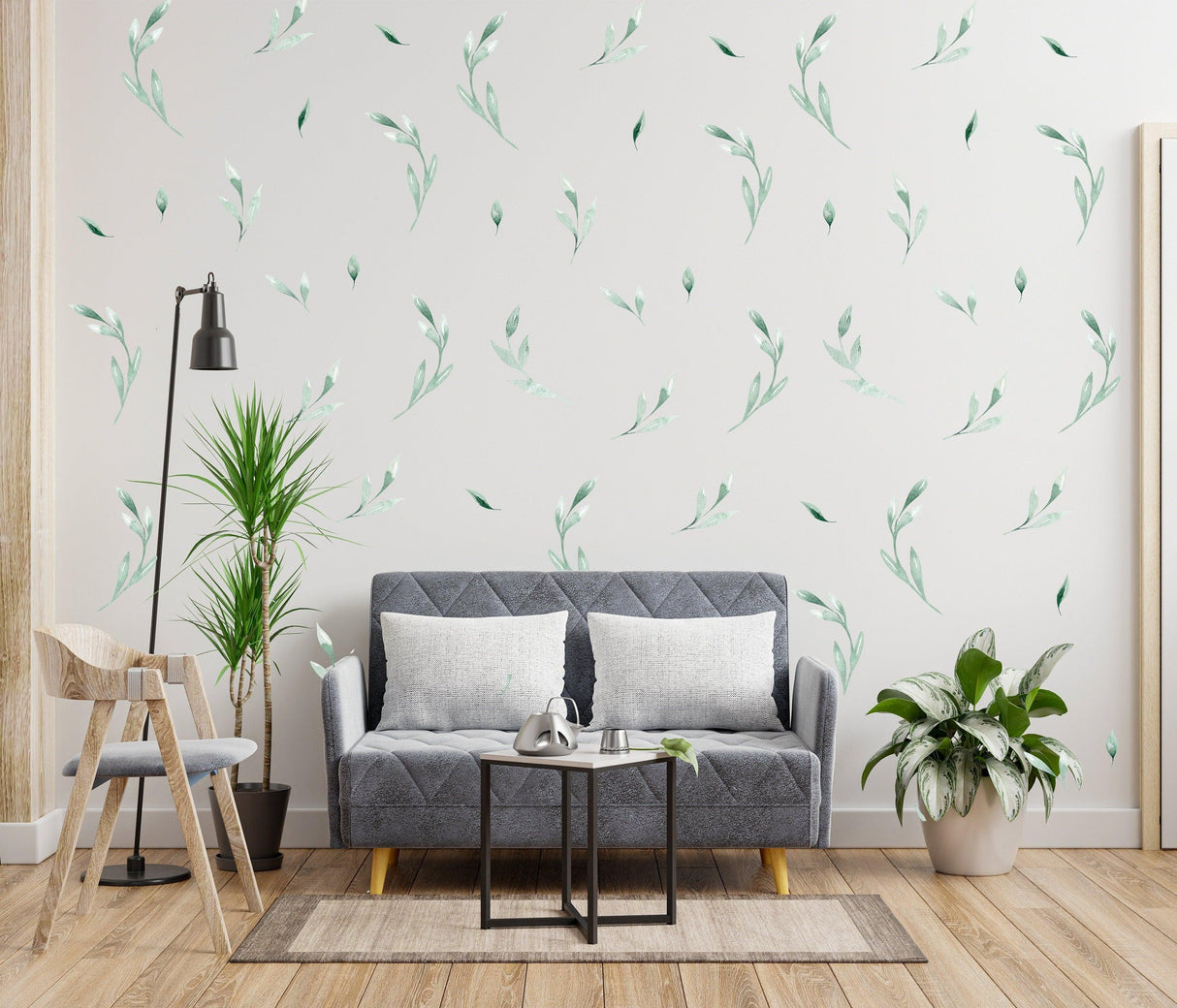 Living room with leaf wall decor stickers and plants, showcasing a serene and natural aesthetic.