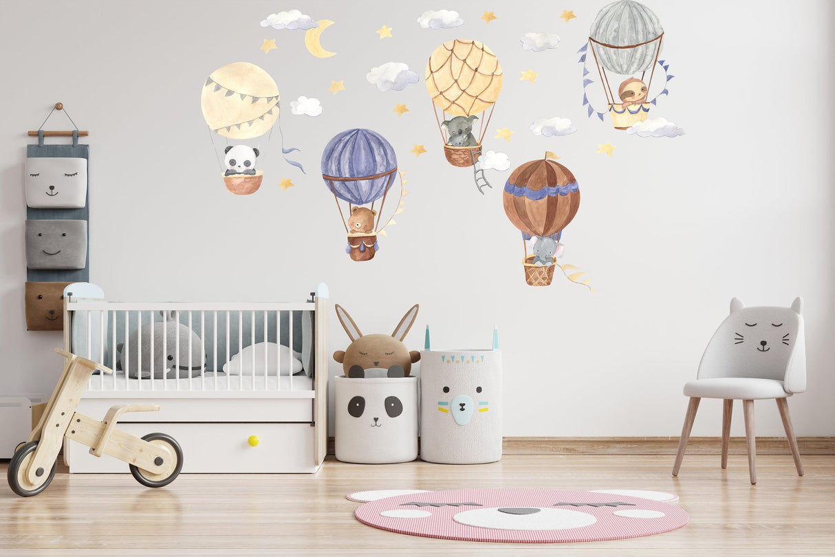 Vibrant hot air balloon wall stickers featuring adorable animals and clouds in a cozy nursery setting.