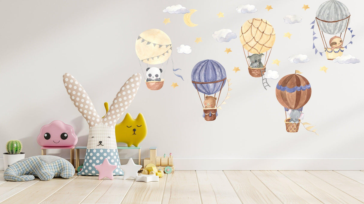 Colorful hot air balloon wall stickers with cute animals, stars, and clouds in a whimsical nursery decor.