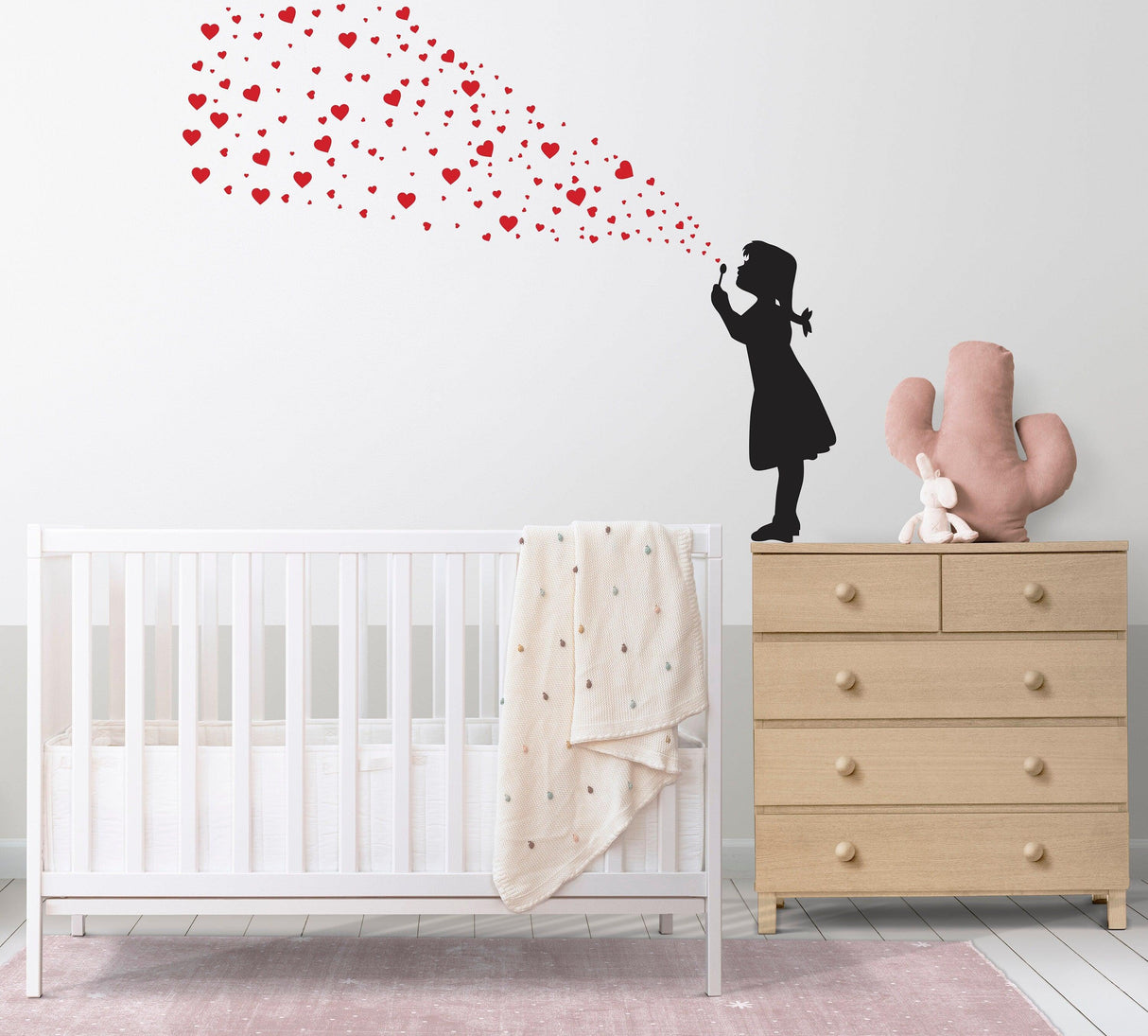 Heart Bubbles Girl wall sticker blowing heart-shaped bubbles above a nursery crib and dresser.