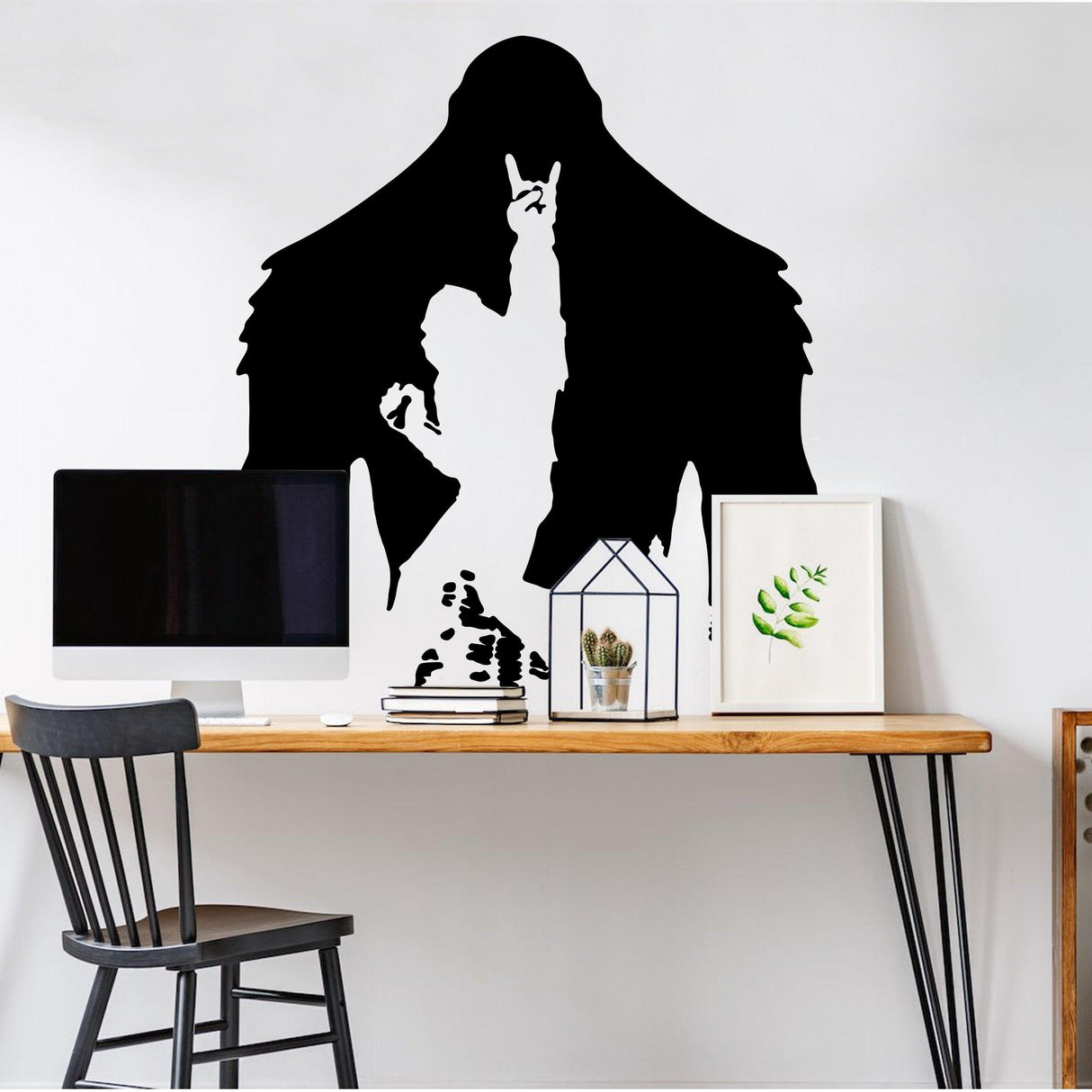 Sasquatch sticker silhouette mural above a modern desk with a black chair and decorative items.