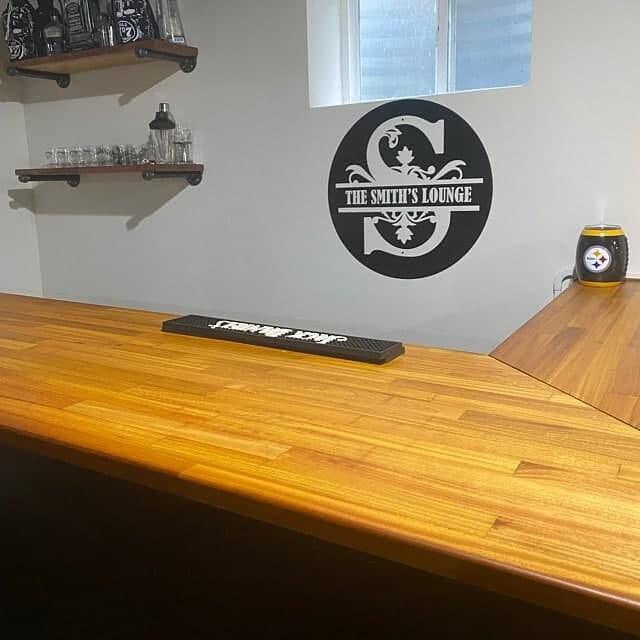 Custom wall decal featuring 'The Smith's Lounge' logo in a stylish home bar setting with a wooden countertop.