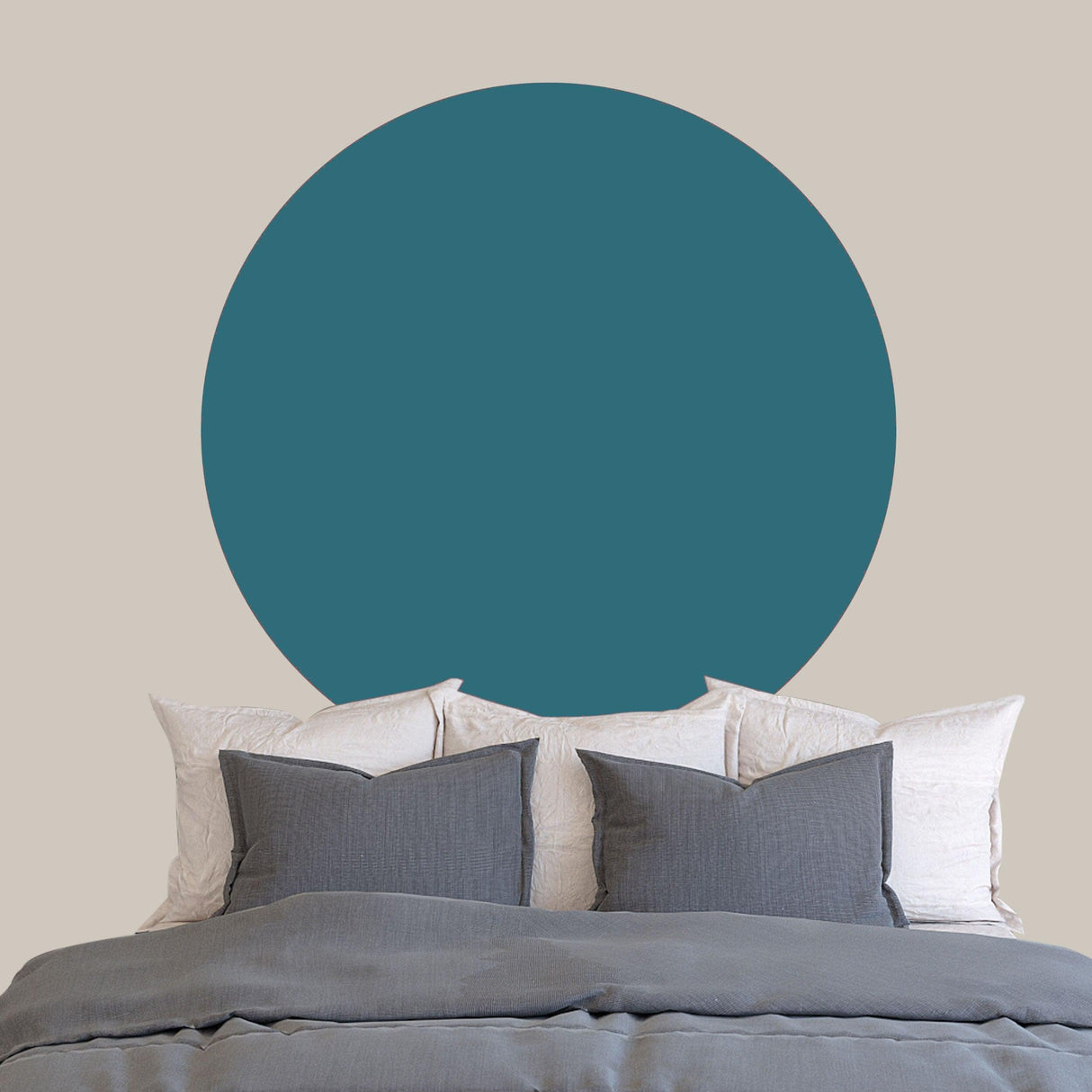 Circle Boho Wall Decal in teal color above a bed with gray pillows, enhancing modern bedroom decor.