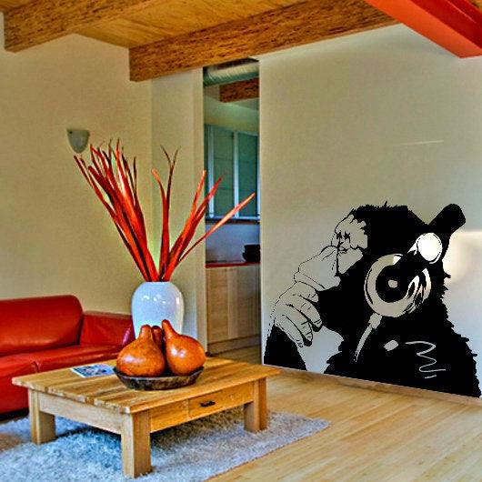 Banksy monkey with headphones wall sticker in modern living room decor, adding creativity and humor.