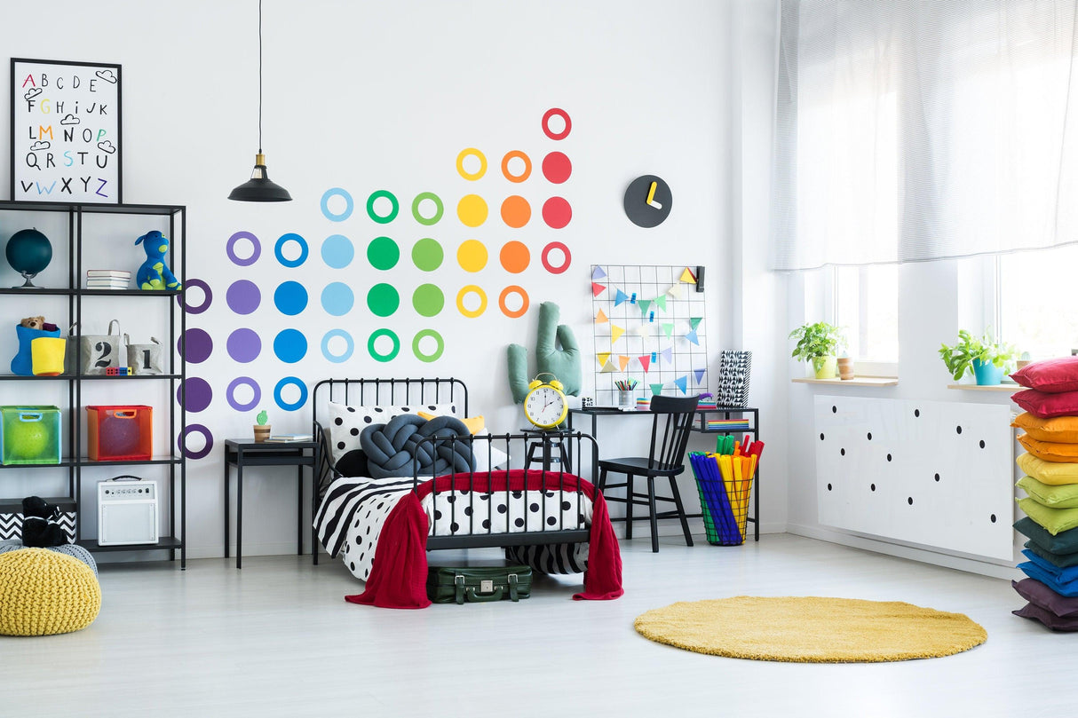 Colorful 36x rainbow circle wall decals brighten a vibrant bedroom with playful decor on walls and furniture.