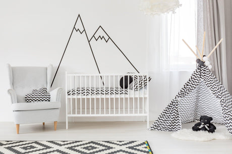 Stylish nursery featuring Black Mountain Line Peel and Stick decals above a white crib and patterned teepee.