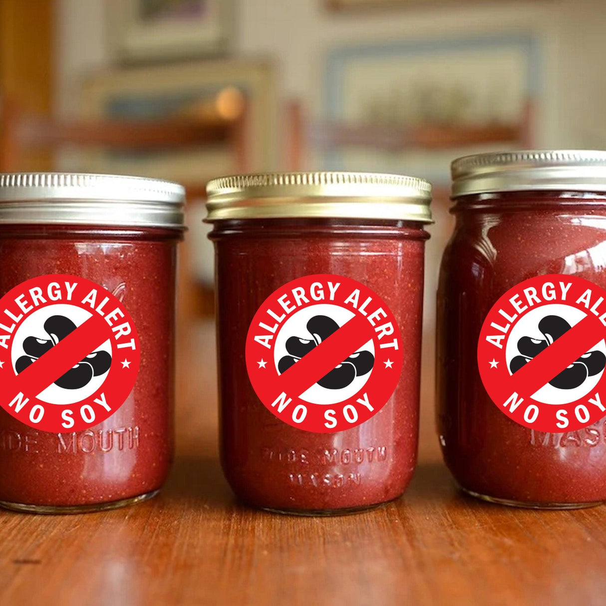Three jars with 'Allergy Alert No Soy' stickers displayed on a wooden table.