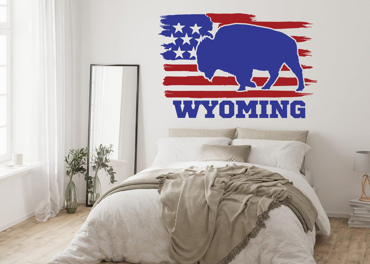 Wyoming wall decal featuring a blue bison silhouette with American flag stripes, adding rustic charm to any room.
