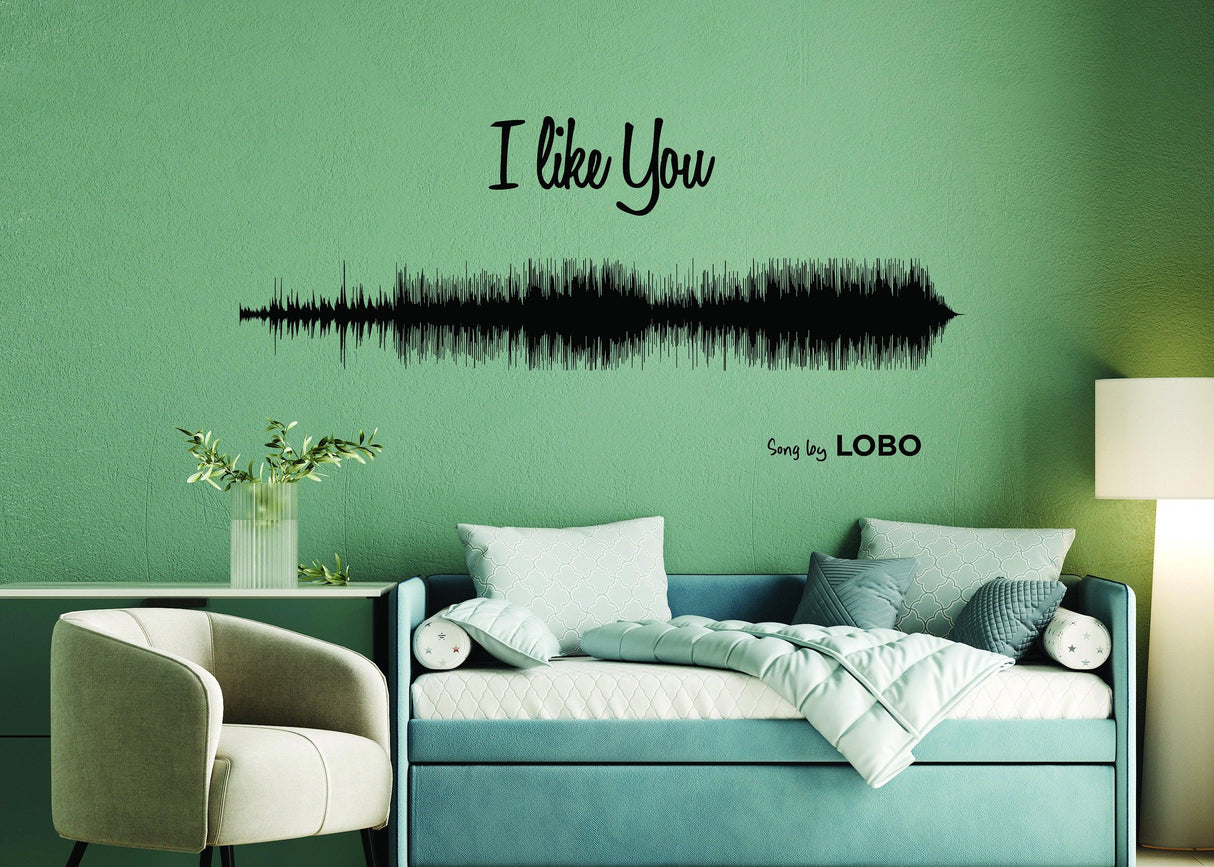 Personalized sound wave art decal of the song 'I Like You' by Lobo on a green wall in a cozy living space.