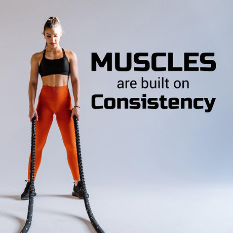 Fitness inspiration wall sticker with text 'Muscles are built on Consistency' and a woman exercising with ropes.