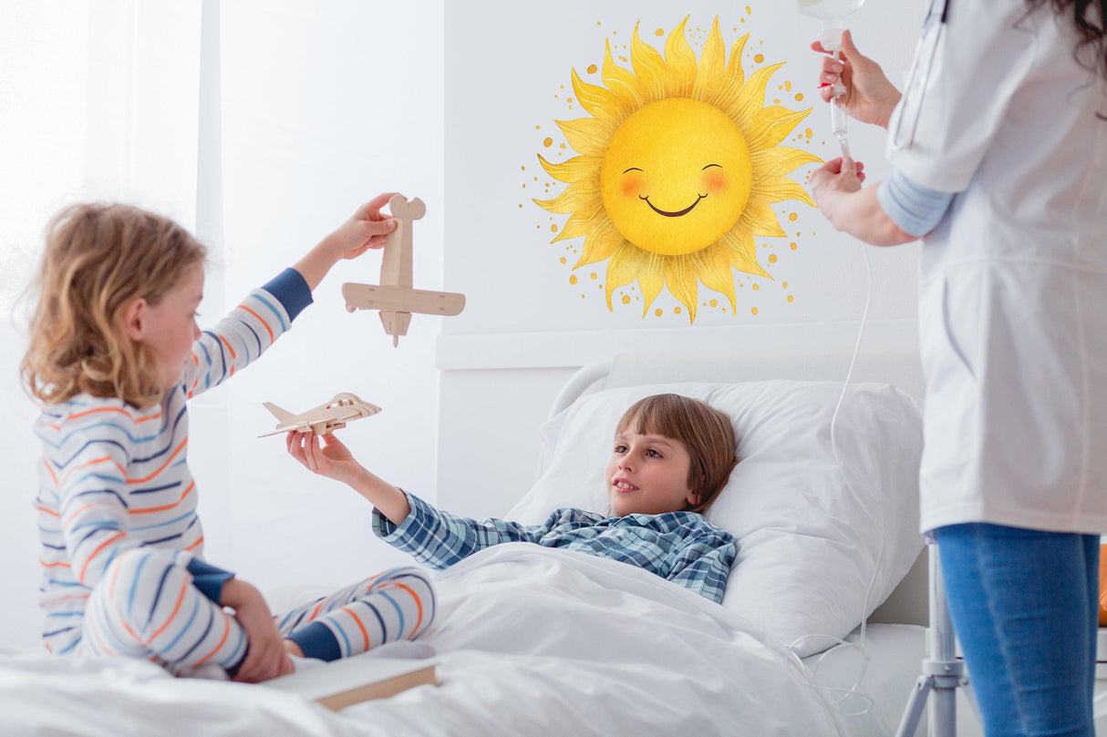 Two children playing with wooden planes beside a cheerful sunburst wall sticker in a cozy room.
