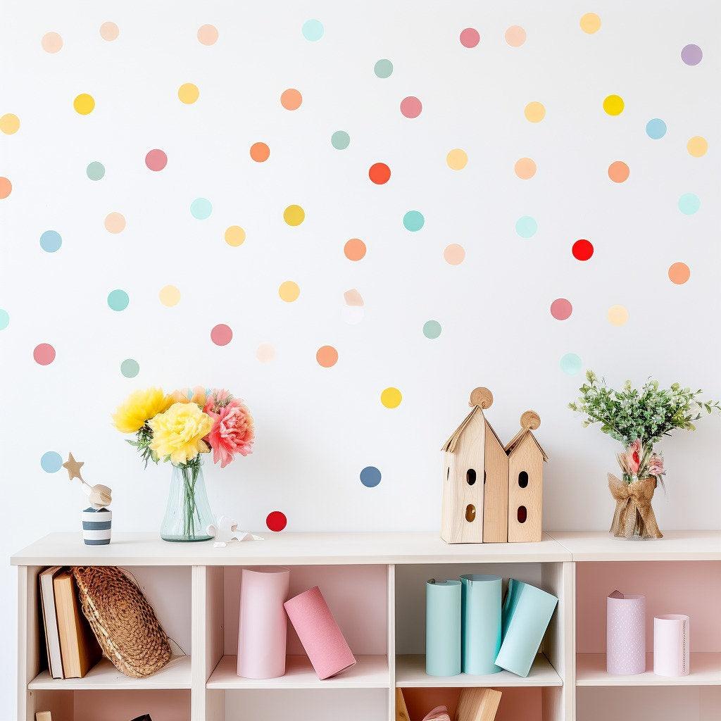Colorful watercolor round dot decals on a white wall in a playful kids playroom with decorative items.