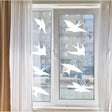 Anti-collision bird stickers applied to a window to prevent bird collisions and enhance home decor.