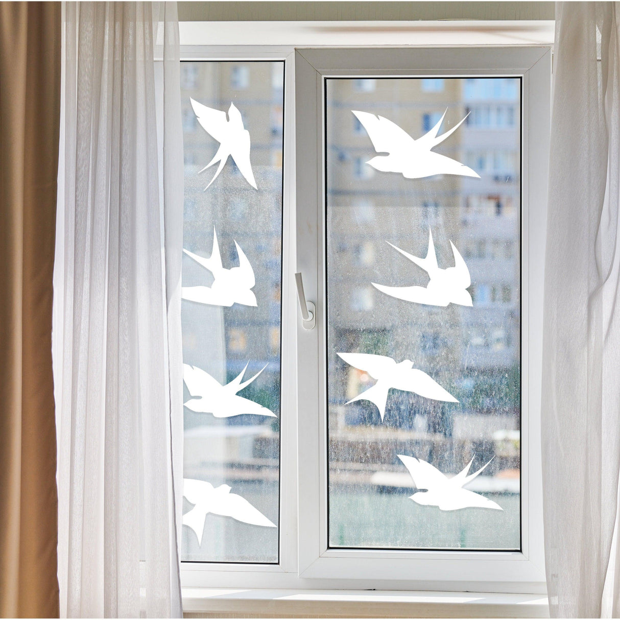 Anti-collision bird stickers applied to a window to prevent bird collisions and enhance home decor.